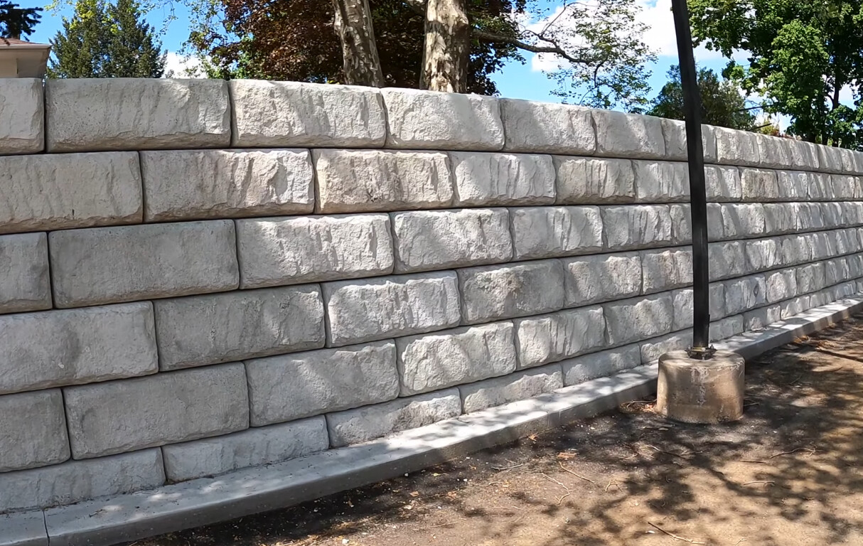 Professional decorative concrete retaining wall with textured stone finish in Torrington, CT